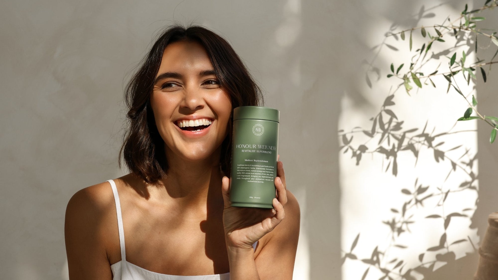 Mother smiling, holding Mothers replenishment - Revitalise Superblend